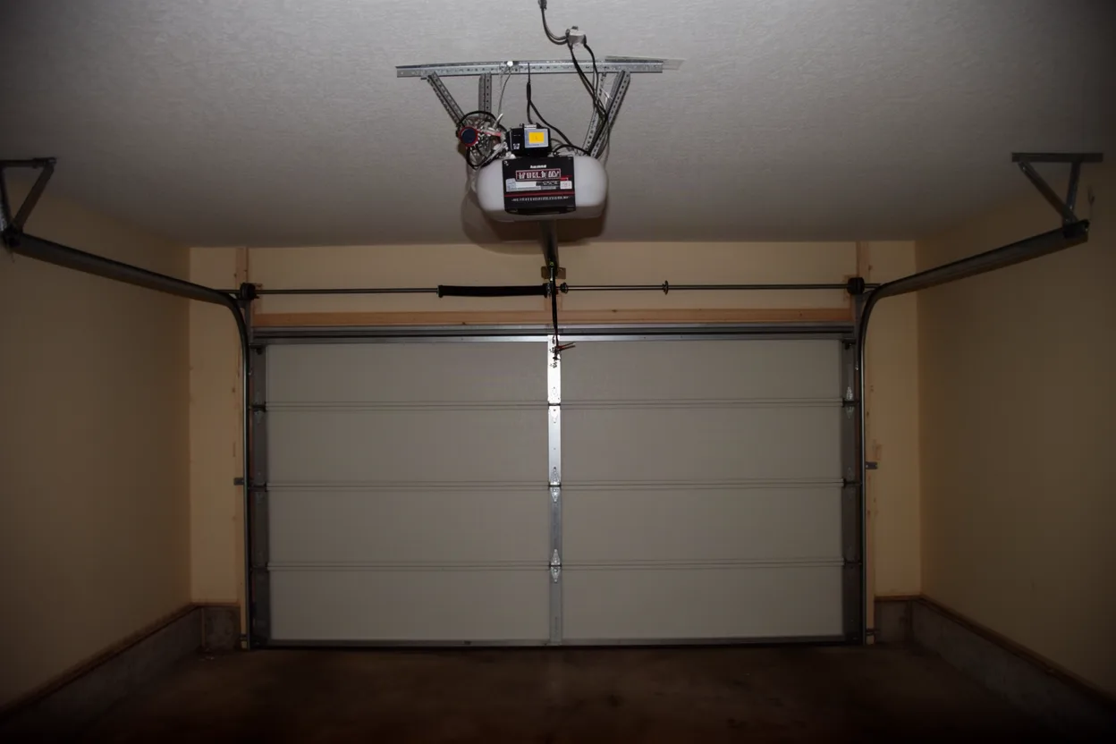 Garage door and ceiling-mounted opener