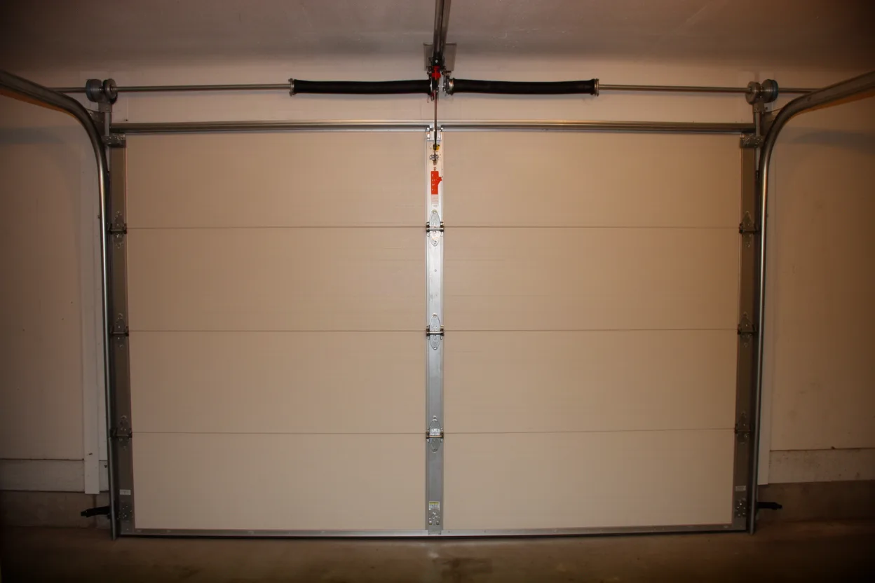 A garage door track with rollers